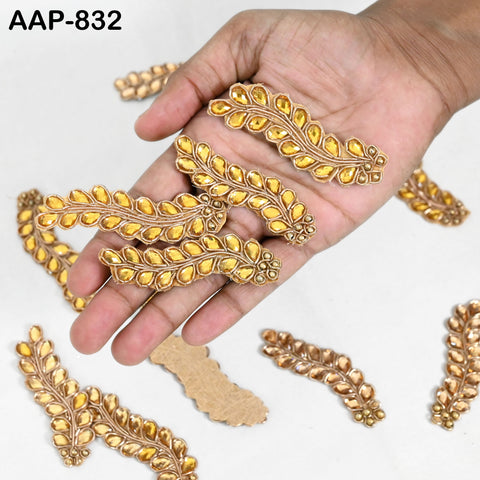 Hand-beaded golden Zardozi applique, showcasing intricate embroidery with metallic gold thread and rhinestones.