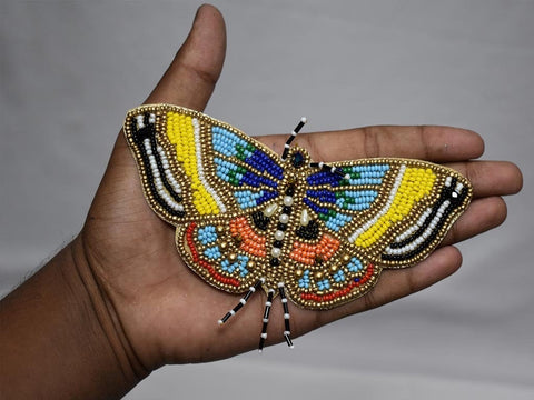 Beaded butterfly patch in hand for close up