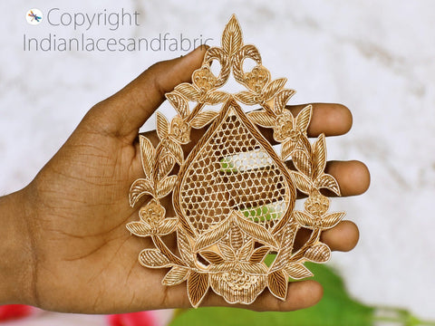 Close-up of a gold Zardozi applique showing intricate metallic threadwork, sequins, and bead detailing in a floral motif — perfect for couture embroidery