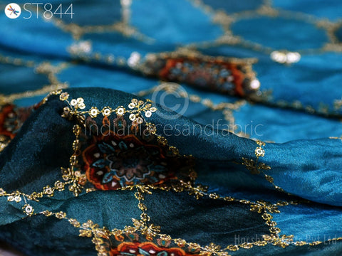 Detailed embroidery with sequin and thread work on blue fabric