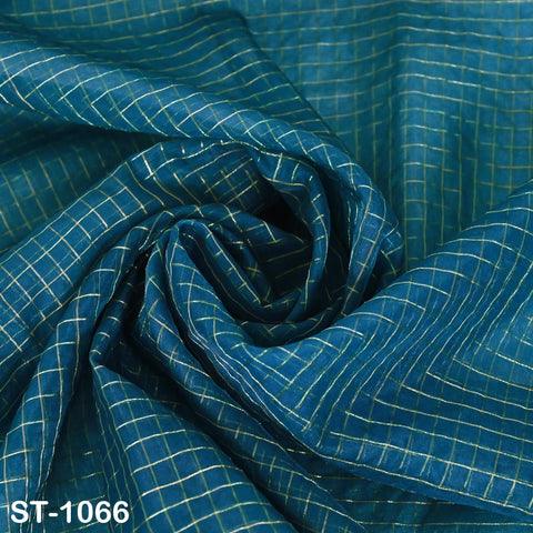 Teal blue-toned organza chunni displayed on table and backdrop, suitable for weddings, gifting, or fabric crafting.
