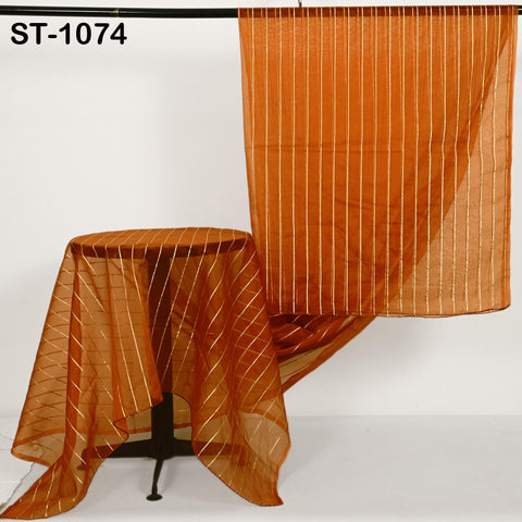 Burnt orange-hued Indian dupatta in sheer fabric with subtle shimmer from vertical zari striping, displayed in elegant folds.