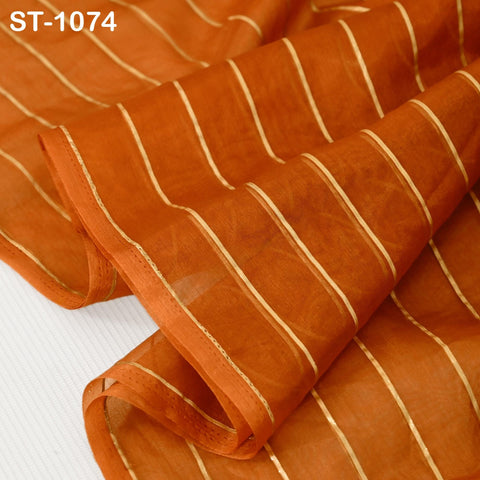 Indian ethnic organza scarf in warm orange tone with vertical gold detailing, displayed in a soft, flowing style.