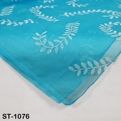 Close-up of turquoise organza dupatta with delicate white stitching in a botanical pattern, traditional ethnic accessory.