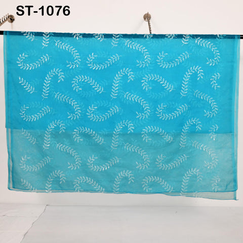 Lightweight sheer organza fabric in turquoise with leaf embroidery, used as bridal veil, scarf, or craft fabric.