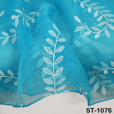 Bright turquoise blue dupatta with white threadwork leaves, organza fabric draped for festive and wedding fashion.