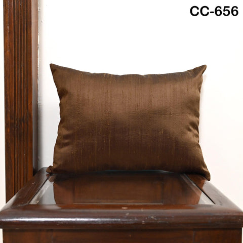 Handmade iridescent brown Dupioni silk lumbar pillowcase shown on sofa.