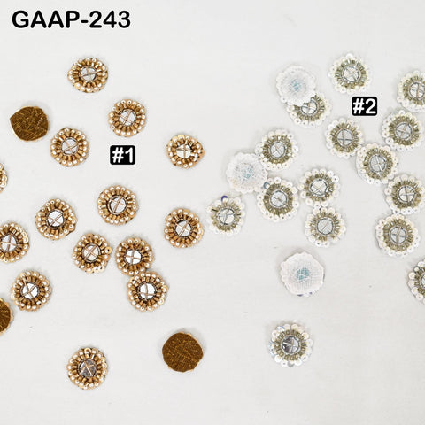 50 Pcs Hand-crafted mirror embellishment patches arranged on fabric, 50 gold round mirror appliques, ideal for DIY clothing or home décor.