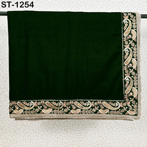 Close-up of floral embroidery on green velvet shawl fabric