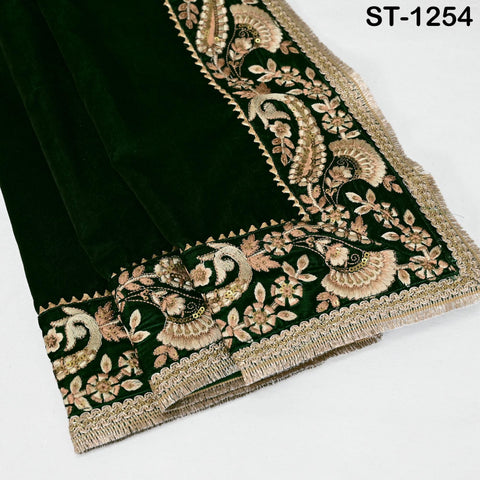 Close-up of floral embroidery on green velvet shawl fabric