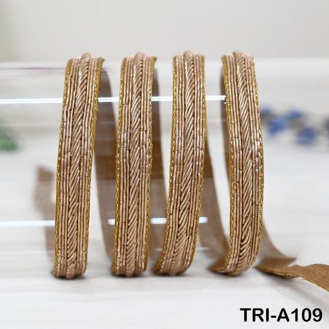 Handcrafted gold zari trim made by Indian artisans using traditional Zardozi embroidery technique.