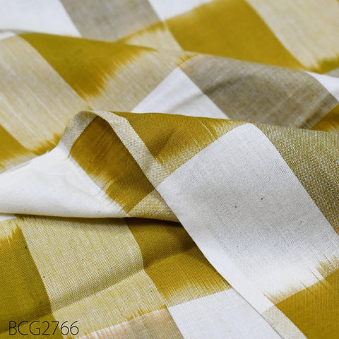 a close-up view of a fabric with a yellow and white checkered pattern. The fabric appears to be made of a soft, textured material, possibly cotton or linen. The image does not contain any text or other discernible objects or actions.
