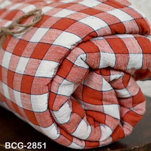 A rolled-up red and white checkered fabric with a twine loop tied around it.