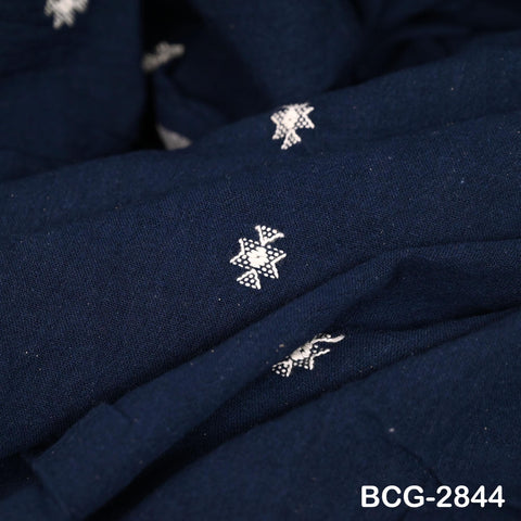 a close-up view of a dark blue fabric with white star-shaped embroidered designs.