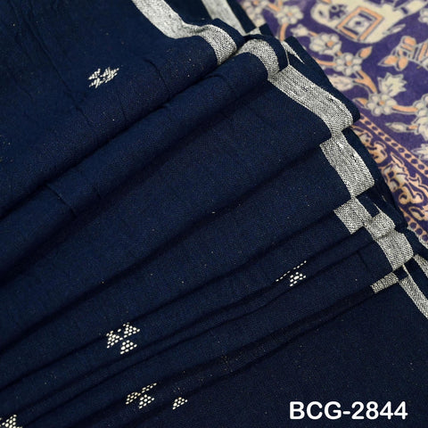 A close-up view of a dark blue fabric with white geometric patterns, folded and creased.