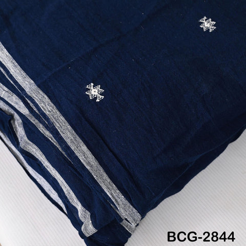 a close-up view of a dark blue fabric with white embroidered designs on it.