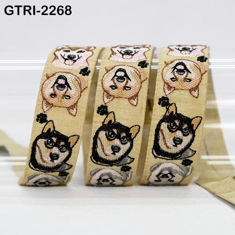 a beige ribbon with a repeating pattern of dog faces, including a Shiba Inu dog, a Golden Retriever, and a Chihuahua.