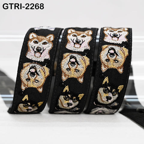 A black and gold dog embroidered ribbon with multiple dog faces on it, arranged in a row.