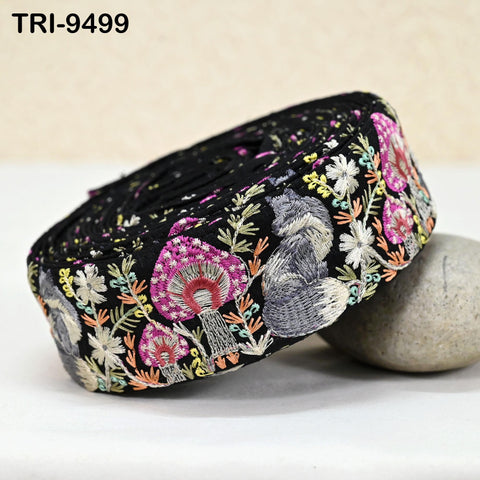 A close-up image of a decorative fabric with a floral pattern, featuring a variety of colorful flowers and mushrooms.
