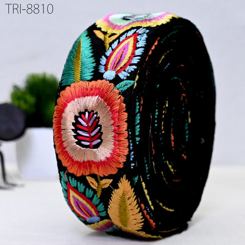 a black, circular object with a vibrant, colorful floral pattern.