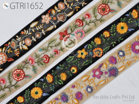 a collection of decorative fabric pieces with intricate floral embroidery. The fabric pieces feature a variety of colorful flowers and leaves, creating a visually appealing and vibrant display.