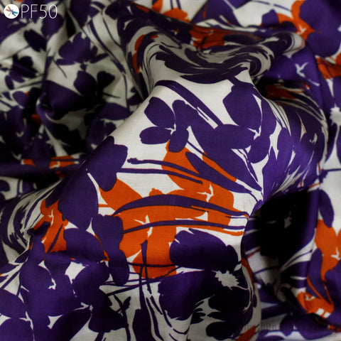 a close-up view of a fabric with a vibrant floral pattern in shades of purple, orange, and white.