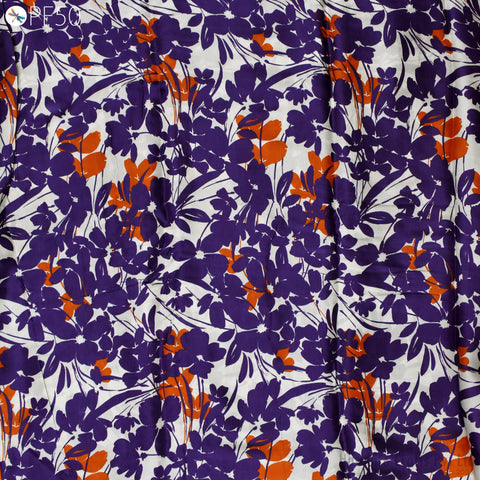a close-up view of a fabric with a floral pattern in shades of purple and orange. The pattern consists of various shades of purple flowers interspersed with orange flowers, creating a visually striking and vibrant design.
