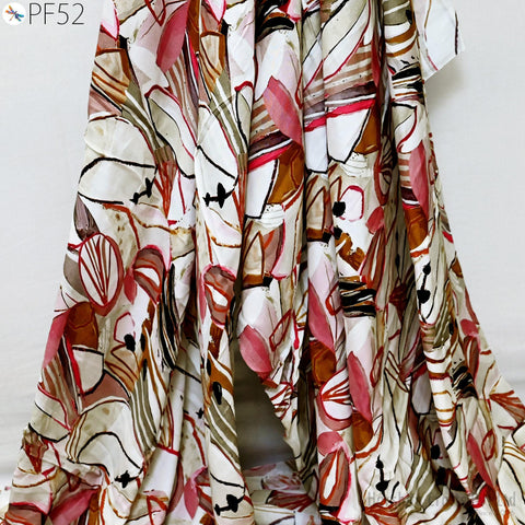 a close-up view of a colorful, abstract patterned fabric, possibly a dress or garment. The fabric features a mix of red, white, and brown colors, along with various geometric shapes and designs.