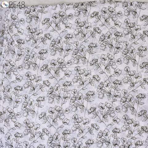 a repeating pattern of black and white floral designs on a light-colored background.