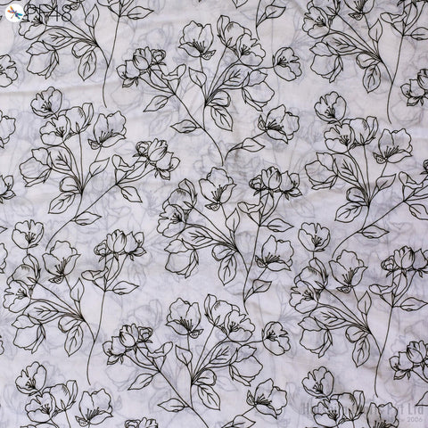 a repeating pattern of black and white floral designs on a light-colored background.