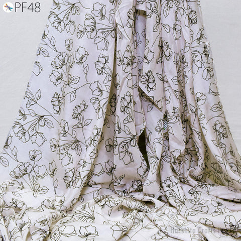 a close-up view of a fabric with a floral pattern, featuring black outlines of flowers and leaves.