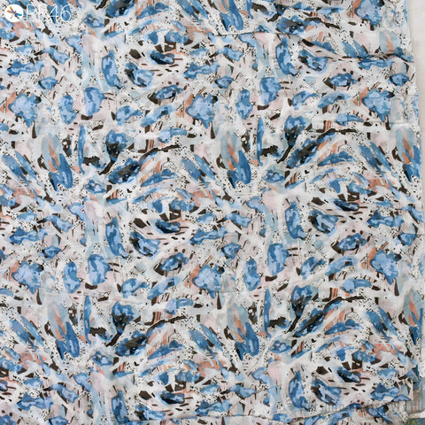 The image is a collage of various abstract patterns and textures, including splashes of blue, white, and brown colors. The patterns appear to be a mix of organic and geometric shapes, creating a visually interesting and dynamic composition.