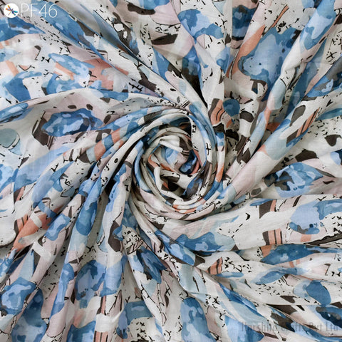 The image is a close-up view of a fabric with a floral pattern, featuring a mix of blue, white, and orange colors. The fabric appears to be made of cotton and is twisted in a spiral pattern, creating a visually interesting and textured appearance.