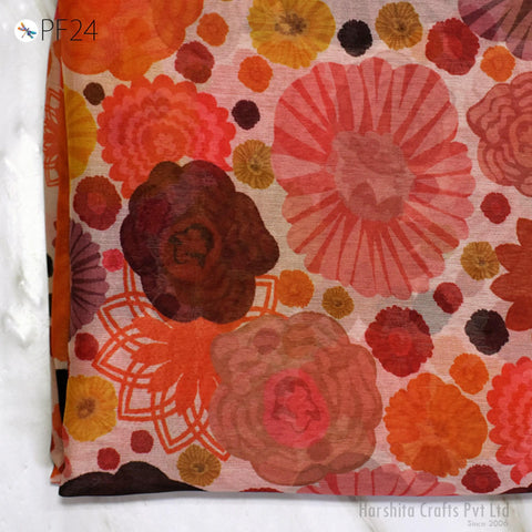 a vibrant and colorful floral pattern, with a variety of flowers in shades of orange, pink, and yellow. The pattern appears to be a printed fabric or textile, with the flowers spread across the entire surface. The image does not contain any text or other discernible objects, and the focus is solely on the floral design.