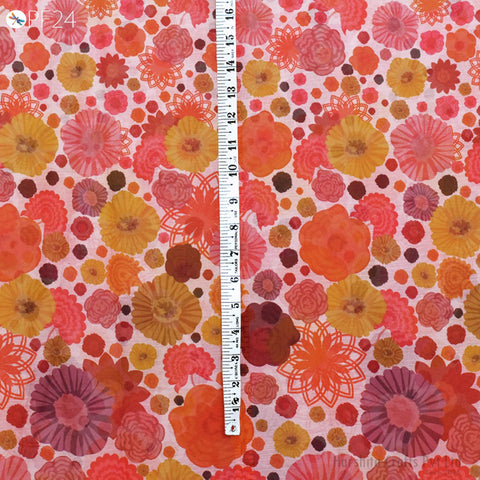 a vibrant and colorful floral pattern, with various shades of orange, pink, and yellow flowers scattered across the surface. A ruler is placed vertically in the center of the image, providing a sense of scale and dimension to the floral design.