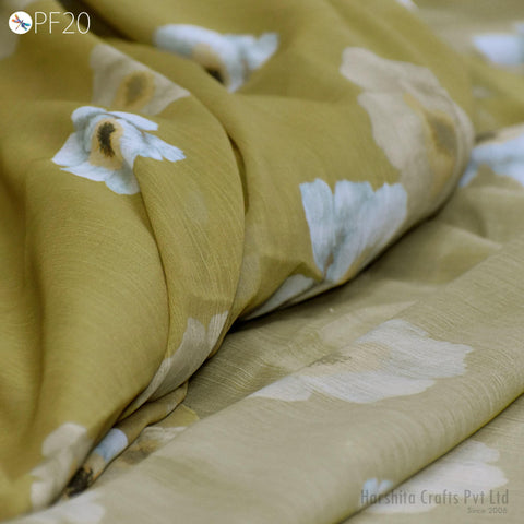 a close-up view of a fabric with a floral pattern, featuring a mix of green and white colors.