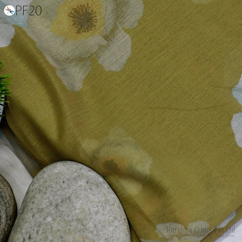 a close-up view of a fabric with a floral pattern, resting on a surface next to a rock.