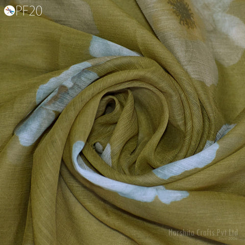 a close-up view of a fabric with a floral pattern, featuring a mix of green and white colors.