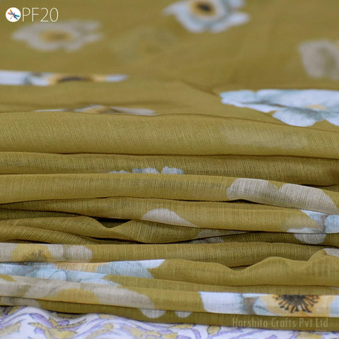 A close-up image of a fabric with a floral pattern, featuring a yellow and white color scheme.