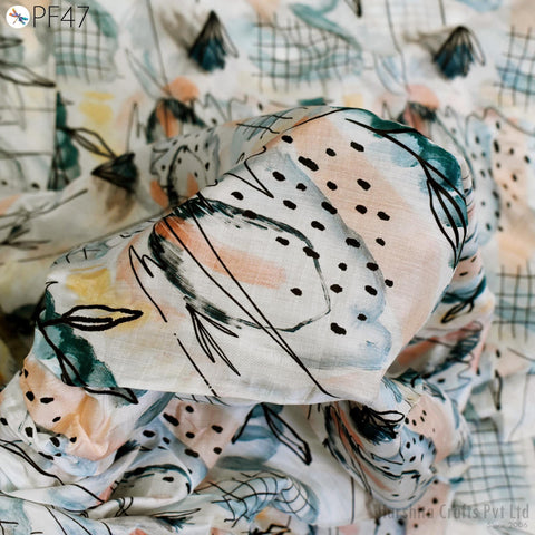 a close-up view of a fabric with a colorful, abstract pattern of dots and lines. The fabric appears to be a piece of cloth or textile, with a variety of colors and shapes creating a visually interesting design.
