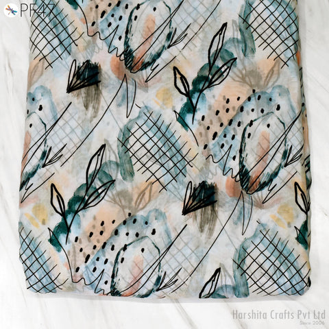a close-up view of a fabric with a pattern of abstract designs and shapes, including lines, dots, and floral elements. The fabric appears to be a textile or material with a unique and visually interesting design.