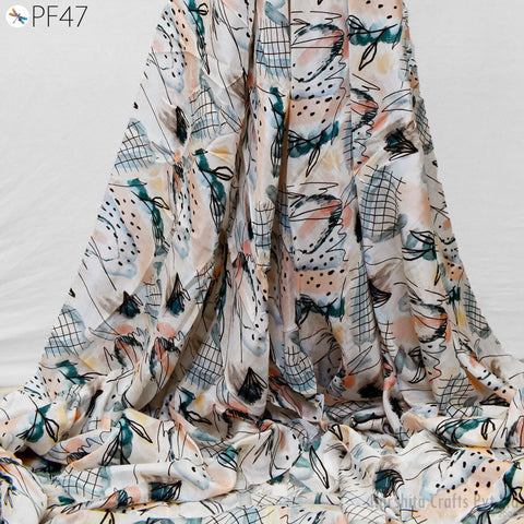 a close-up view of a fabric with a colorful, abstract pattern. The fabric appears to be made of a soft, flowing material and has a textured, wrinkled appearance.