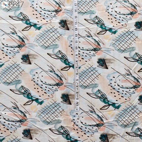 a close-up view of a fabric with a repeating pattern of abstract shapes and lines in various shades of blue, green, and pink. The pattern is composed of a grid-like design with a mix of organic and geometric elements. The fabric appears to be a piece of clothing or textile, with the pattern and measurements visible on the fabric.
