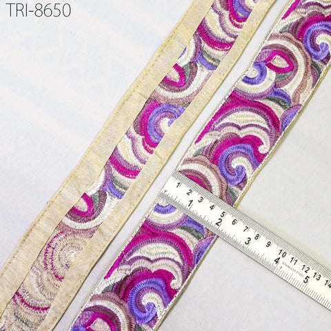two pieces of fabric with a colorful, swirling pattern. A ruler is placed on top of the fabric, indicating the size of the fabric.
