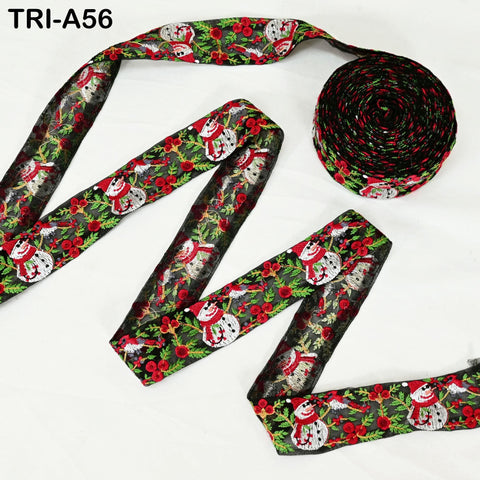 a spool of red and green ribbon with a snowman pattern, along with a smaller spool of ribbon with a similar snowman pattern.