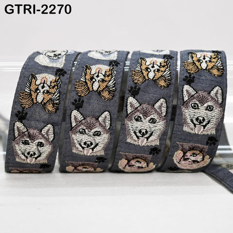 A group of gray and white dog-themed embroidered ribbons, with each ribbon featuring a repeating pattern of dog faces and paw prints.
