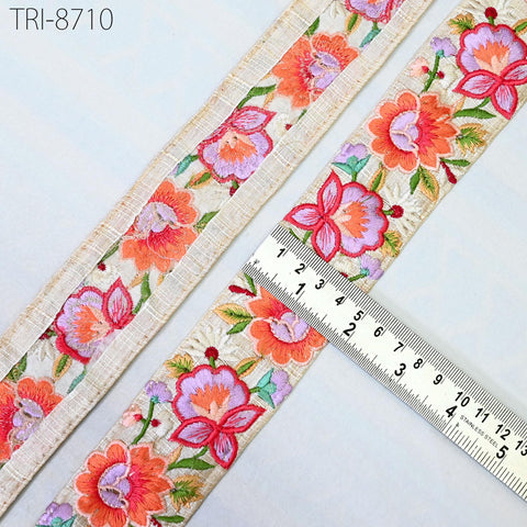 a close-up view of a decorative fabric with a floral pattern, featuring a ruler for scale.