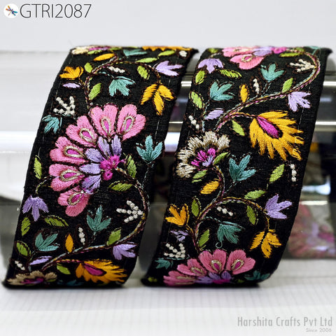 two decorative fabric pieces with intricate floral embroidery in various colors, including pink, yellow, and purple. The pieces appear to be handmade and are displayed on a white surface.