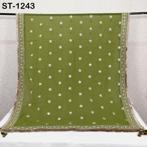 a green and gold embroidered sari with white star patterns.