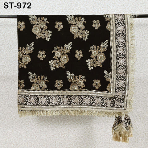 a black and gold embroidered textile with a decorative border, hanging on a rod.